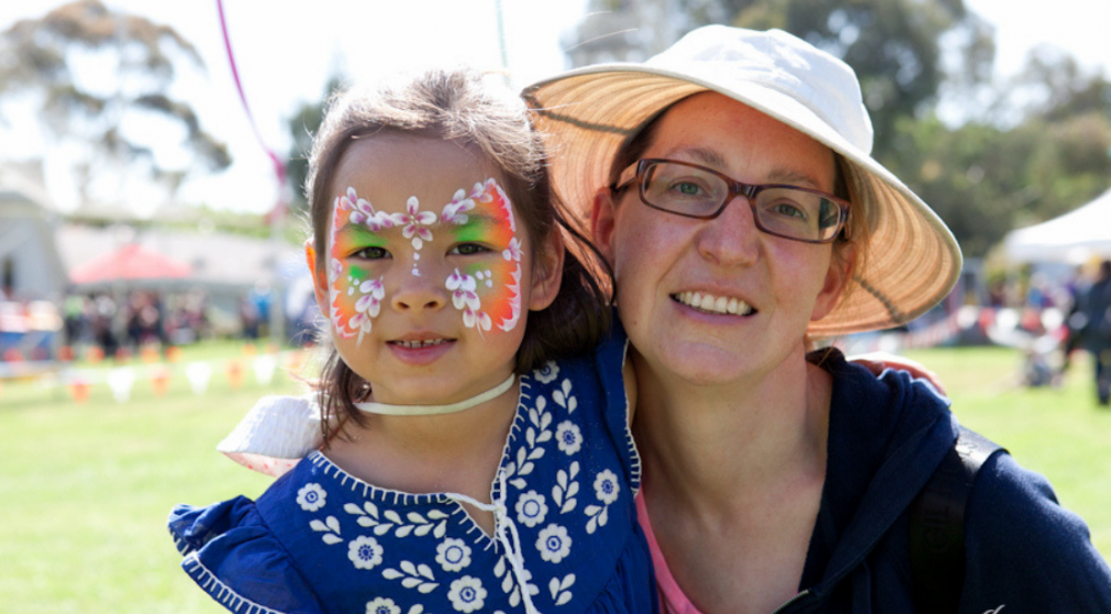 a lady and a young girl with face paint