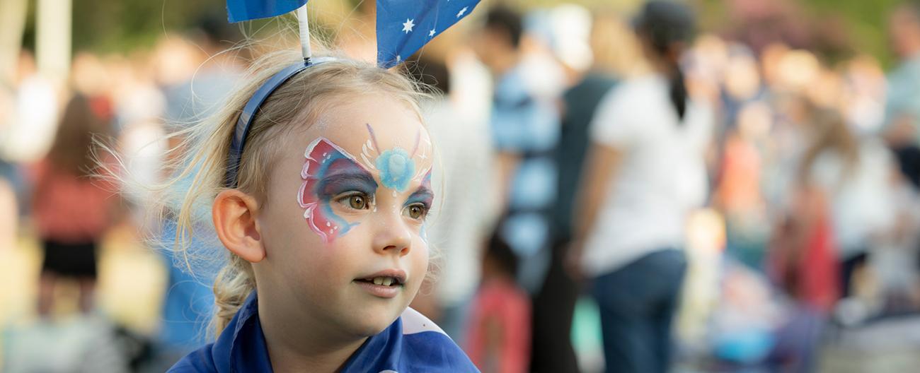 Child with face painted at an event