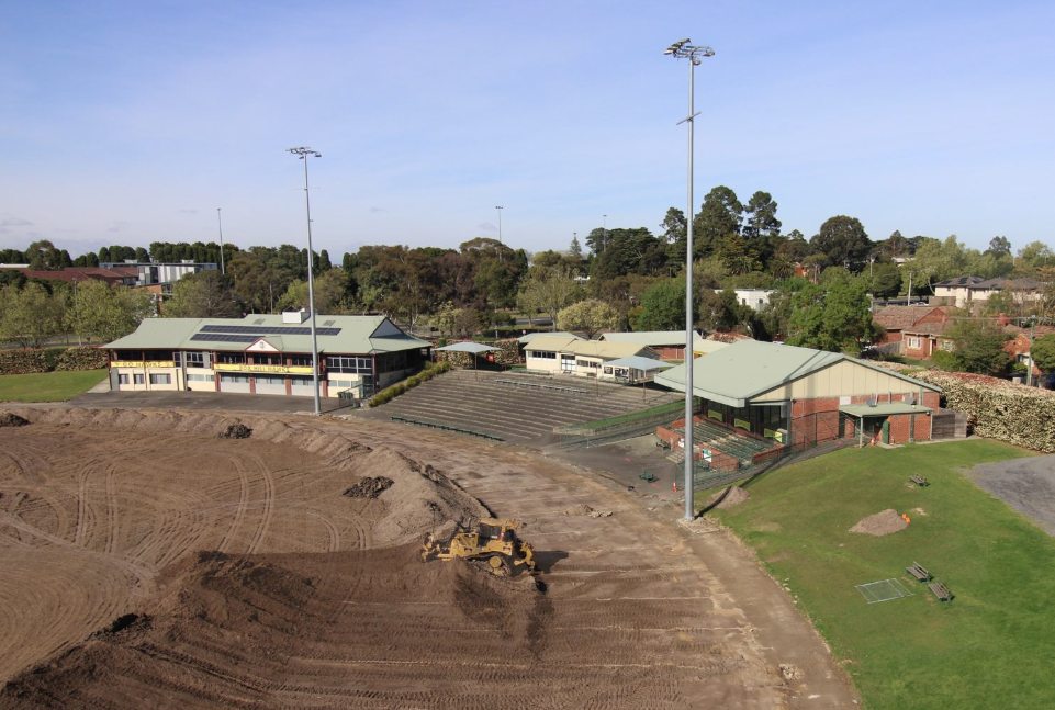 an aerial shot of an oval with the grass removed
