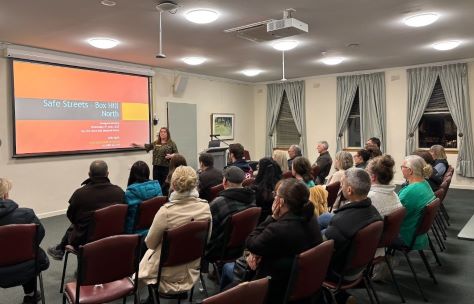 people in a community meeting looking at a presentation