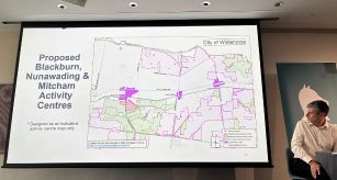 a person looking at a projector screen that is displaying a map