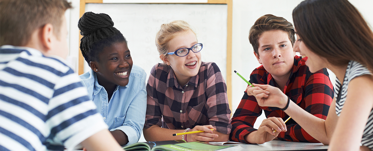 a group of teen students on a classroom project