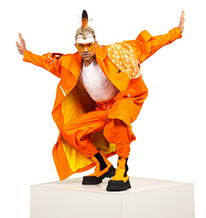 Male performer in orange outfit