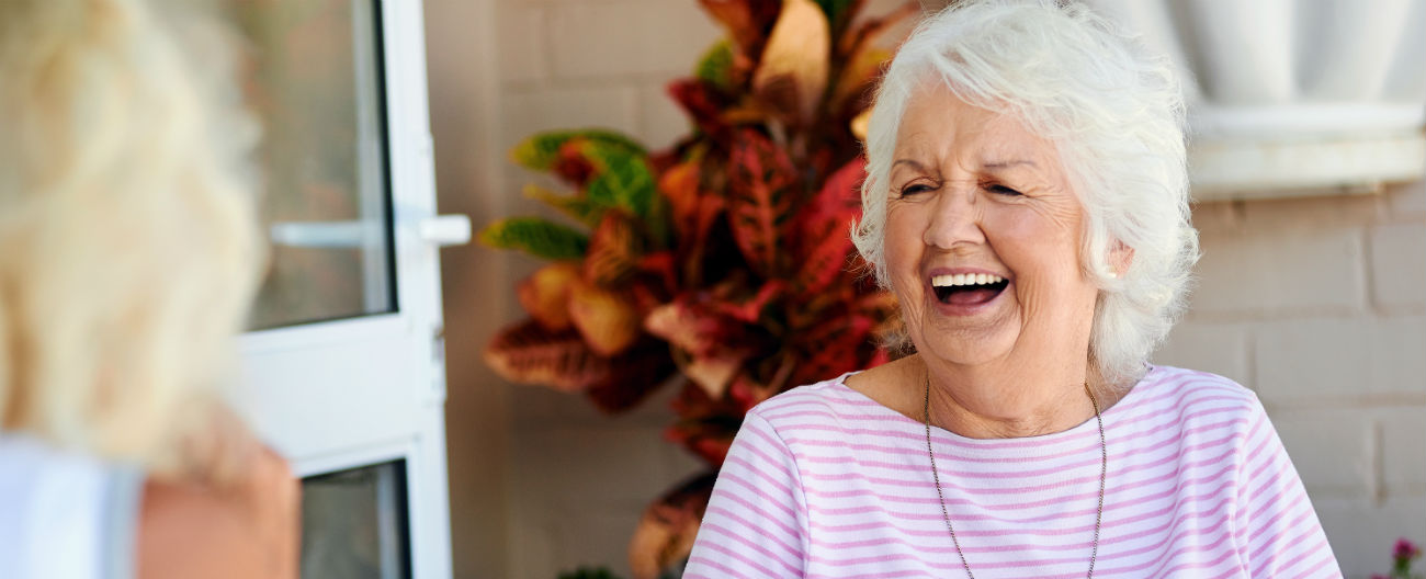 WHACS - Older woman laughing with cup of tea