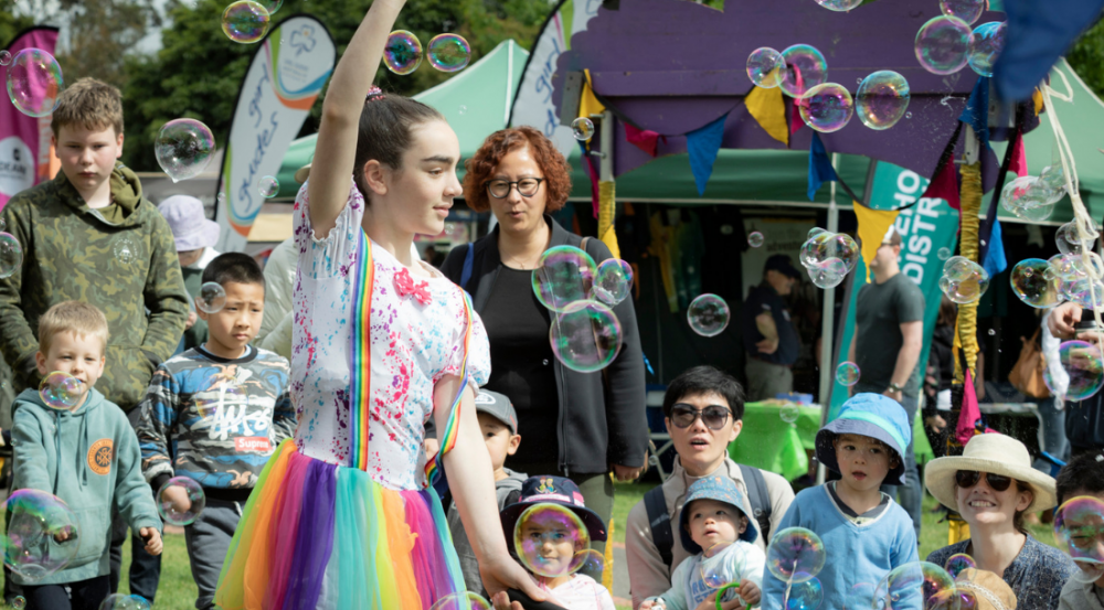 a girl dressed up as fairy with bubbles