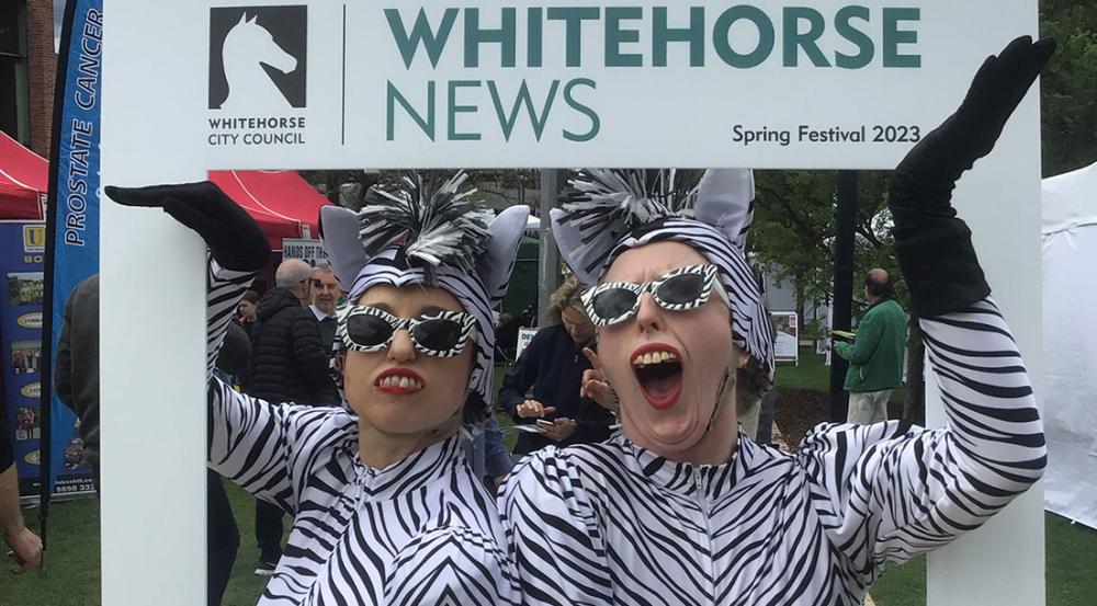 Whitehorse News roving frame with two women dressed in leopard print
