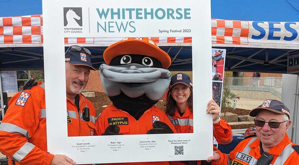Whitehorse News roving frame with group of SES workers
