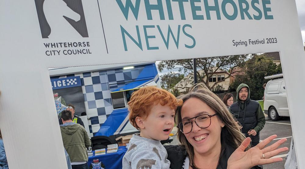 Whitehorse News roving frame with woman waving and her son