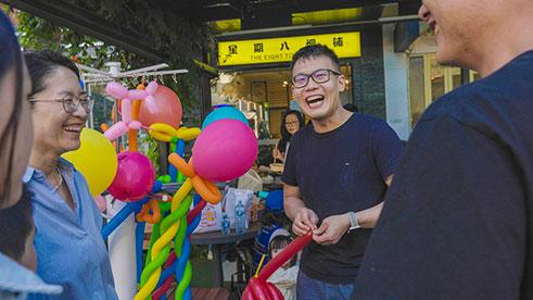 smiling people in front of balloons