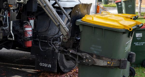 Image of truck collecting recycling bin 