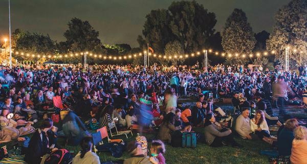 Community gathering at night with festoon lighting