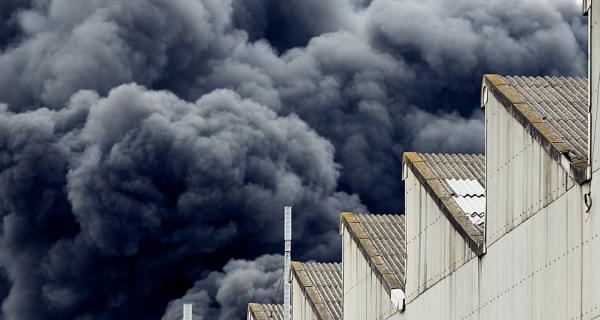 dark smoke raising from a large fire