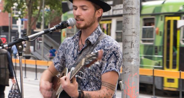 busker playing a guitar