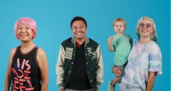 three people standing in front of a blue background