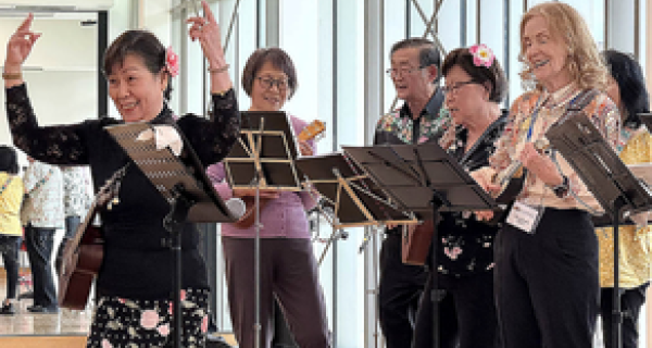 U3A Band singing lady with arms in air