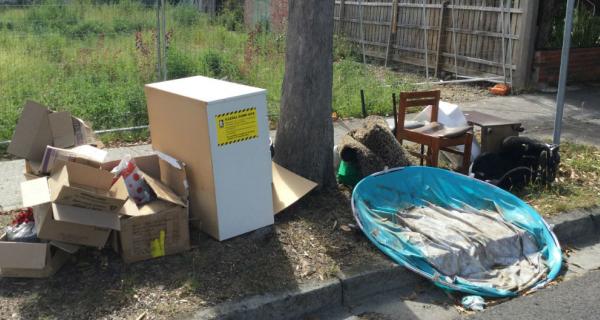 Dumped rubbish in front of vacant block