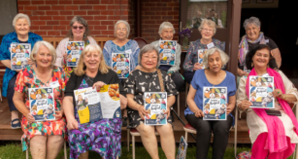 Whitehorse women with their biscuit tin recipe book