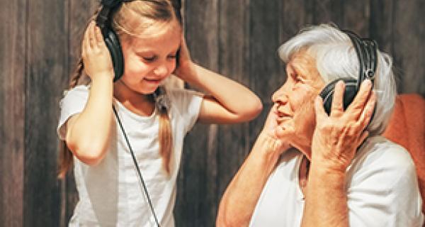 Grandmother and grandaughter listening to music together