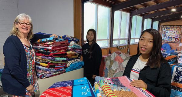  Janelle, Rachel and Ni Tin Par with some of the quilts Dream Stitches is sending to Gippsland