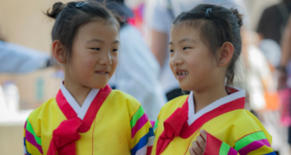 Two young girls in gowns smile