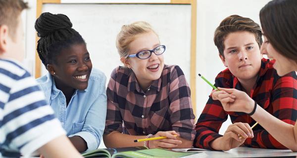 a group of teen students on a classroom project