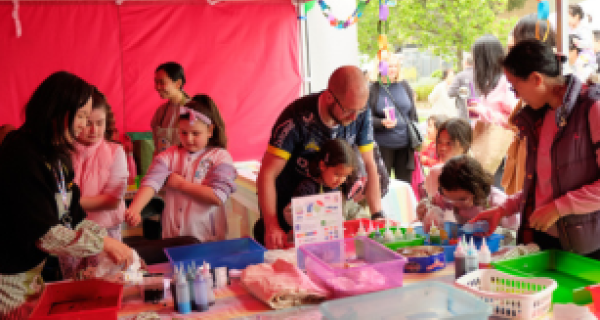 Festivals - Planning Event - CTA.png group of adults and children creating tie die bags at tables