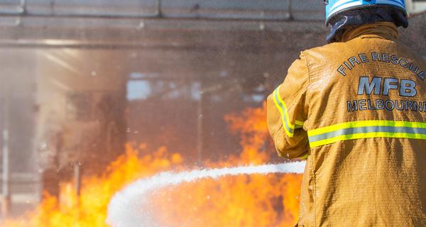 An MFB fire brigade officer fighting fire