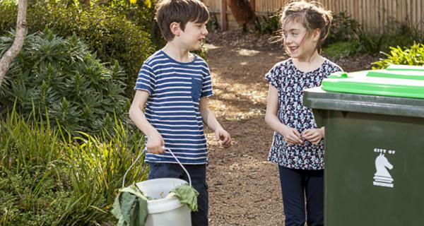 Image of placing waste in garden bin