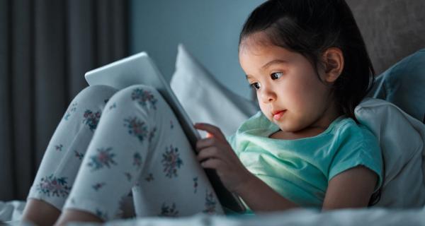 Young child playing with an iPad