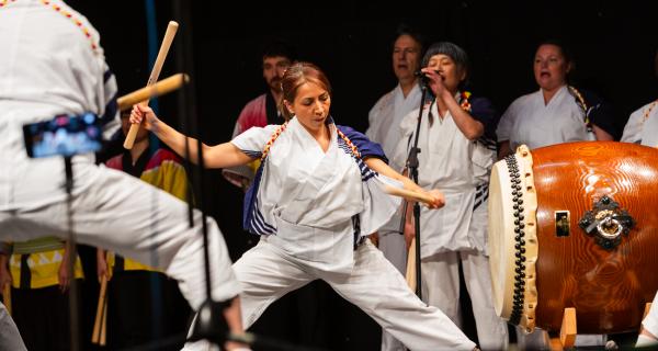 image of woman playing japanese drums