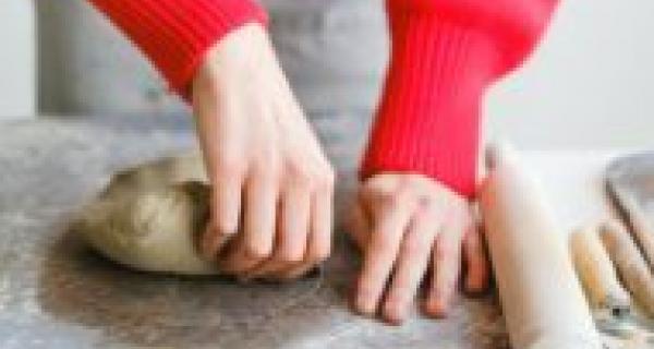 Hands moulding clay on a bench