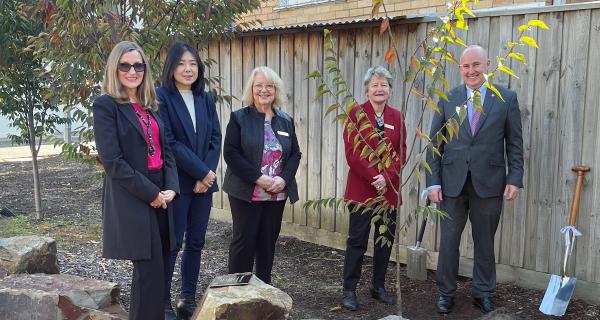 Councillors smiling at the camera next to tree that has just been plated for Matsudo week.