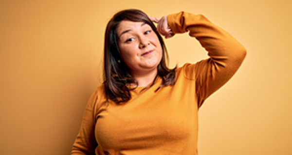 Young woman pointing to brain