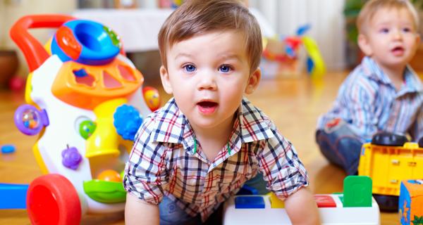 Baby crawling on the floor amongst toys