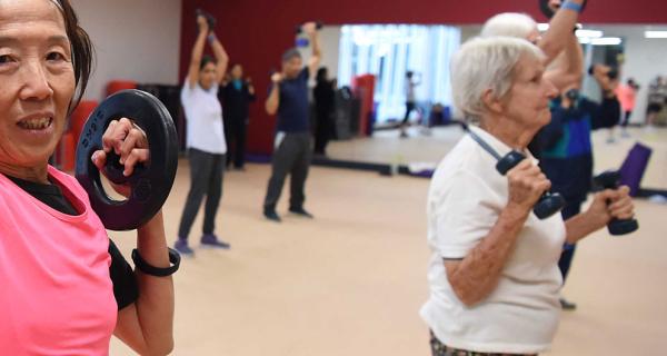 Older people excercising in a gym