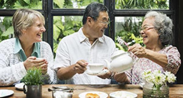 three older people drinking tea
