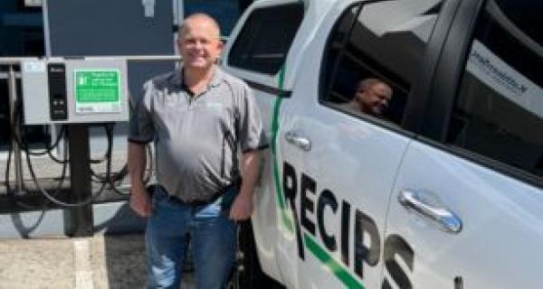 person standing next to a car 