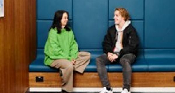 Young person sitting with a youth worker