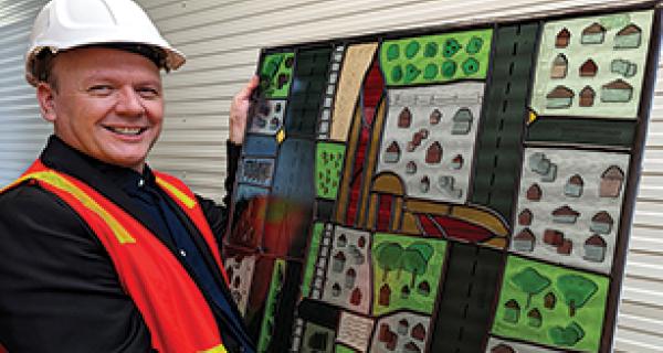 Manager of Arts & Cultural Services looks over a newly repaired section of bicentenary Leadlight