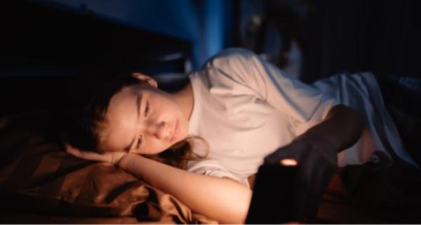 Teenager lying down, trying to get to sleep