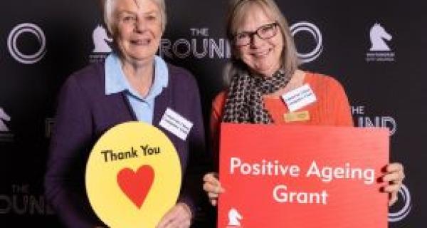 two women holding signing positive ageing grant