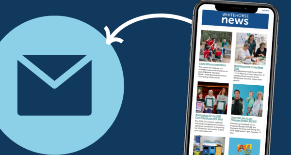 A phone displays a whitehorse News email