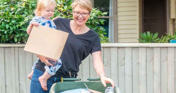 Woman and child at recycling bin