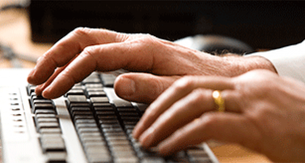 Hands typing on keyboard