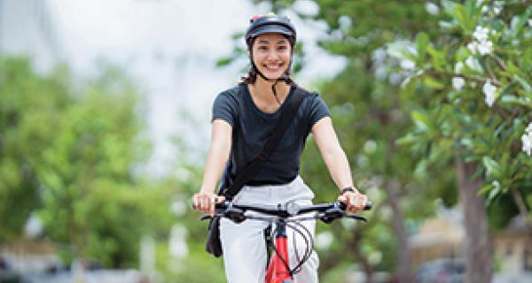 Woman cycling down street