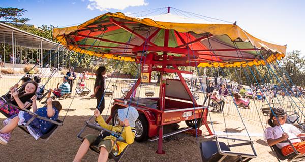 A merry-go-round in motion at an outdoor event