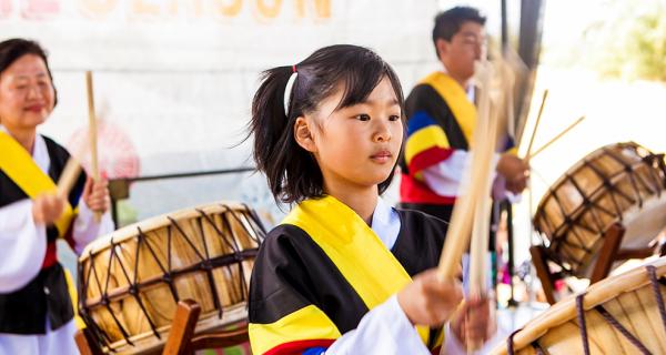 Kids playing traditional drums