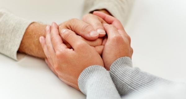 Two sets of supportive holding hands 