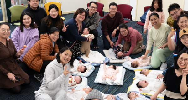 Group of parents with babies lying on the floor