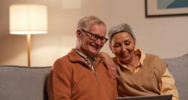 man and lady reading off laptop